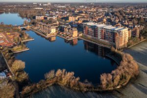 Aerial view of a new housing development with luxury properties overlooking a lake in the lakeside District of Doncaster, UK